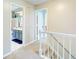Upstairs hallway featuring bathroom and bedroom entries at 1812 Riverton Dr, Suwanee, GA 30024