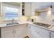 Bright kitchen with subway tile backsplash, granite countertops, and gas range at 1812 Riverton Dr, Suwanee, GA 30024
