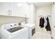 Laundry room with appliances and storage cabinets at 1812 Riverton Dr, Suwanee, GA 30024