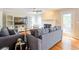 Open-concept living room with hardwood floors, fireplace, and plenty of natural light at 1812 Riverton Dr, Suwanee, GA 30024