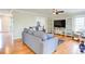 Cozy living room featuring hardwood floors, comfortable seating, and a ceiling fan at 1812 Riverton Dr, Suwanee, GA 30024