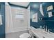 Classic blue bathroom featuring a subway-tiled shower/tub combo and modern fixtures at 2284 Dauphine St, East Point, GA 30344