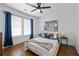 Bright bedroom featuring a modern ceiling fan, hardwood floors, and elegant window curtains at 2284 Dauphine St, East Point, GA 30344