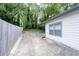 Long driveway leading to a backyard with a privacy fence and lush, mature trees at 2284 Dauphine St, East Point, GA 30344