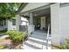 Inviting front porch with a seating area and stylish brick columns at 2284 Dauphine St, East Point, GA 30344