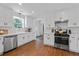 Well-appointed kitchen with stainless steel appliances, white cabinetry, and hardwood floors at 2284 Dauphine St, East Point, GA 30344