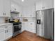 Bright kitchen with stainless steel appliances, subway tile backsplash, and sleek cabinetry at 2284 Dauphine St, East Point, GA 30344