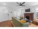 Inviting living room featuring a decorative fireplace, hardwood floors, and modern ceiling fan at 2284 Dauphine St, East Point, GA 30344