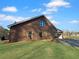 Exterior view of a brick home highlighting the attached garage and spacious lawn at 5321 Tuscany Dr, Douglasville, GA 30135