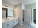 Bathroom features a double vanity, tiled floors, and modern light fixtures at 5321 Tuscany Dr, Douglasville, GA 30135