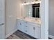 Bathroom features double vanity with white cabinets and light fixtures at 5321 Tuscany Dr, Douglasville, GA 30135