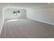 A large carpeted bonus room features natural light and is perfect for a playroom or office at 5321 Tuscany Dr, Douglasville, GA 30135