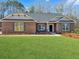 Charming single story brick home features a large green lawn and gray shutters at 5321 Tuscany Dr, Douglasville, GA 30135