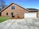 View of brick home garage with an attached driveway and green space at 5321 Tuscany Dr, Douglasville, GA 30135