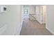 Upstairs hallway boasts carpeted floors and access to multiple rooms at 5321 Tuscany Dr, Douglasville, GA 30135