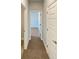 Hallway features neutral carpeting and multiple doors, creating a seamless flow at 5321 Tuscany Dr, Douglasville, GA 30135