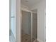Modern shower with tiled walls, glass door, and mosaic accent strip at 5321 Tuscany Dr, Douglasville, GA 30135