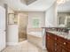 Spacious bathroom features a soaking tub, a walk-in shower, and a double vanity with granite countertops at 75 High Top Ln, Atlanta, GA 30328