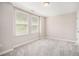Neutral bedroom features a large window, plush carpet and ample natural light, creating a serene space at 75 High Top Ln, Atlanta, GA 30328