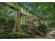 Three-story brick townhome showcases classic architecture and lush, green landscaping at 75 High Top Ln, Atlanta, GA 30328