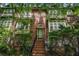 Inviting brick townhome featuring a charming entrance with well-maintained landscaping at 75 High Top Ln, Atlanta, GA 30328