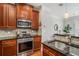 The kitchen showcases stainless steel appliances, dark cabinets, and granite counters at 75 High Top Ln, Atlanta, GA 30328