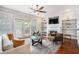 Bright living room features fireplace, built-in shelves, ceiling fan, and French doors at 75 High Top Ln, Atlanta, GA 30328