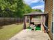 Backyard featuring a patio with a gazebo and a well-maintained lawn, surrounded by a wooden fence and mature trees at 1117 Balvaird Dr, Lawrenceville, GA 30045