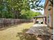 Large, level backyard with a patio and gazebo, fully fenced with mature trees offering privacy and a serene setting at 1117 Balvaird Dr, Lawrenceville, GA 30045