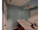 Bathroom featuring a large mirror over a vanity with a stool and neutral blue walls at 1117 Balvaird Dr, Lawrenceville, GA 30045