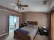 Cozy bedroom with a ceiling fan, and an ensuite bathroom featuring a soaking tub at 1117 Balvaird Dr, Lawrenceville, GA 30045