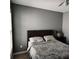 Bedroom featuring neutral gray walls, a window, and a nightstand at 1117 Balvaird Dr, Lawrenceville, GA 30045