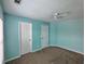 Bedroom with light-blue painted walls, ceiling fan, and carpet at 1117 Balvaird Dr, Lawrenceville, GA 30045