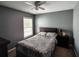 Comfortable bedroom featuring a ceiling fan, window, and stylish gray walls at 1117 Balvaird Dr, Lawrenceville, GA 30045