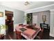 The dining room features dark hardwood floors and neutral paint tones and has seating for four at 1117 Balvaird Dr, Lawrenceville, GA 30045