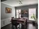 Formal dining room with stylish table setting, wainscoting, and natural lighting at 1117 Balvaird Dr, Lawrenceville, GA 30045