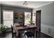 Formal dining room with stylish table setting, wainscoting, and natural lighting at 1117 Balvaird Dr, Lawrenceville, GA 30045