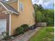 Exterior side view with clean siding, walkway, and landscaping; AC units and trashcan are neatly placed along the side at 1117 Balvaird Dr, Lawrenceville, GA 30045