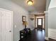 Inviting foyer with hardwood floors, decorative wall trim, and a stylish console table with elegant decor at 1117 Balvaird Dr, Lawrenceville, GA 30045