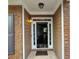 Elegant front door with decorative glass panels and sidelights, set within a charming brick and siding facade at 1117 Balvaird Dr, Lawrenceville, GA 30045