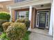 Inviting front porch with classic columns, detailed trim, and a stylish front door surrounded by lush greenery at 1117 Balvaird Dr, Lawrenceville, GA 30045