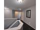 Hallway with wood floors, staircase with white banister, and white doors at 1117 Balvaird Dr, Lawrenceville, GA 30045