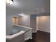 Hallway with wood floors, staircase with white banister, and white doors at 1117 Balvaird Dr, Lawrenceville, GA 30045