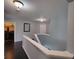 Hallway with wood floors, staircase with white banister, and laundry room on the left at 1117 Balvaird Dr, Lawrenceville, GA 30045