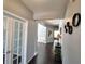 Hallway with hardwood floors leading to dining room with white trim at 1117 Balvaird Dr, Lawrenceville, GA 30045