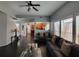 Cozy living room featuring hardwood floors, a ceiling fan, and large windows for natural light at 1117 Balvaird Dr, Lawrenceville, GA 30045