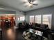 Bright living room with vaulted ceiling, dark wood floors, and open eat-in kitchen at 1117 Balvaird Dr, Lawrenceville, GA 30045