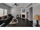Bright living room with vaulted ceiling, dark wood floors, and a charming fireplace at 1117 Balvaird Dr, Lawrenceville, GA 30045