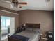 This main bedroom offers a ceiling fan and views of the ensuite bathroom at 1117 Balvaird Dr, Lawrenceville, GA 30045