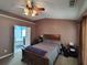 This main bedroom offers a ceiling fan and view of the bathroom with soaking tub through the open door at 1117 Balvaird Dr, Lawrenceville, GA 30045